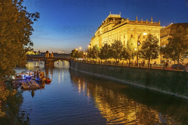 Vltava embankment with the Academy of Arts, Architecture and Design at dusk, Prague, Czech Republic