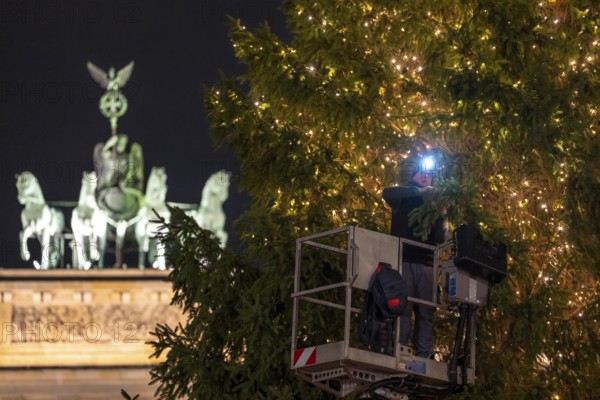The big Christmas tree in front of the Brandenburg Gate, on Pariser Platz, is decorated with fairy