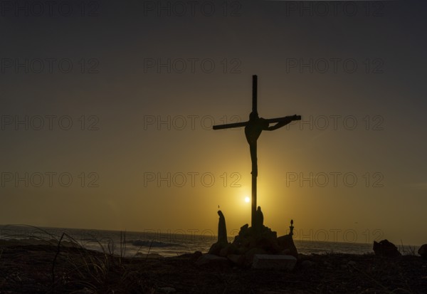 Religious scene, temporary Christian cross on the coast Farol de Cabo Raso lighthouse, SÃ£o Bras de