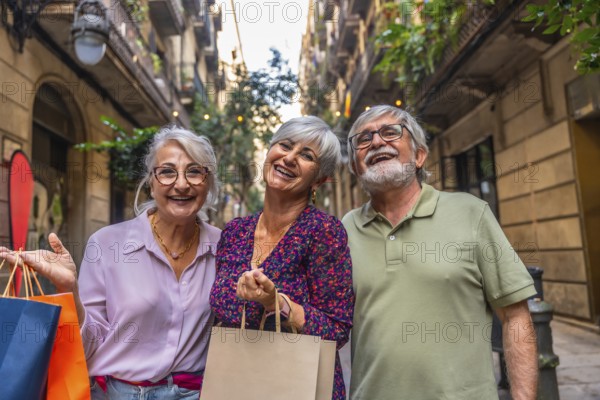 Three smiling senior friends enjoying a day of shopping, holding paper bags while walking in a