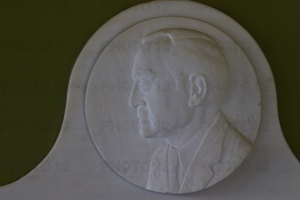 Marble relief depicts Rudolph A. Peterson, a sponsor of the Archaeological Museum in Nemea, marble