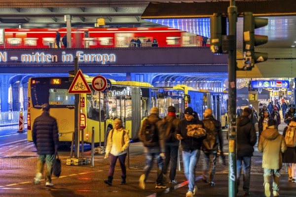 The main train station in Essen, blue illuminated underpass, bus station, am Europaplatz, train on