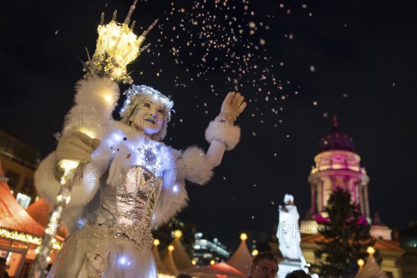 A Black-winged Stilt walker throws confetti at the Christmas market WeihnachtsZauber Gendarmenmarkt