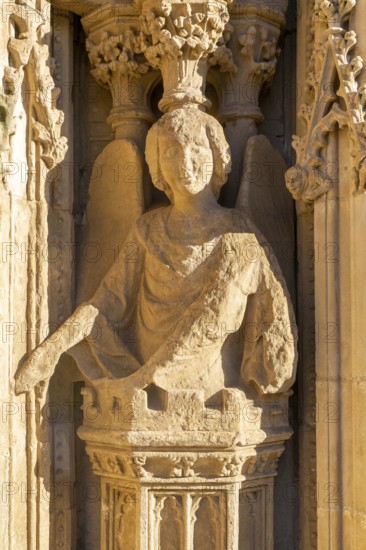 Carved stone figure of winged angel on West Front of Exeter cathedral church, Exeter, Devon,