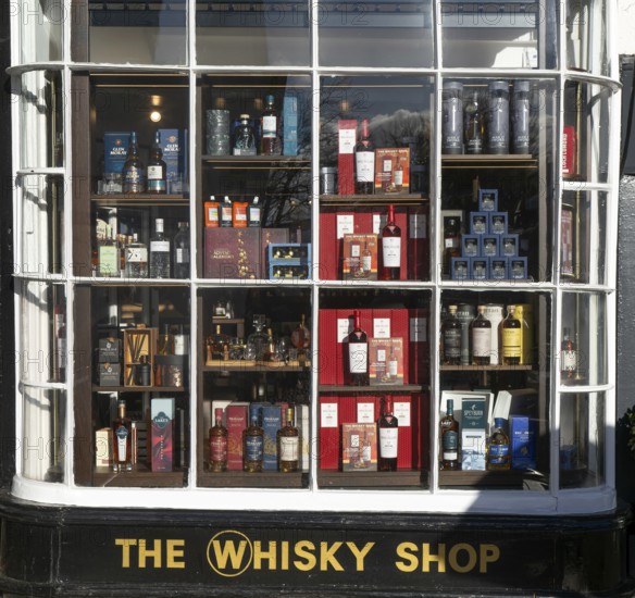 Shopfront window display The Whisky Shop store, Cathedral Close, Exeter city centre, Devon,