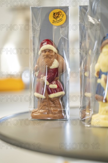 Chocolate Santa figure in red coat wrapped in transparent packaging, Christmas baking, Haselstaller