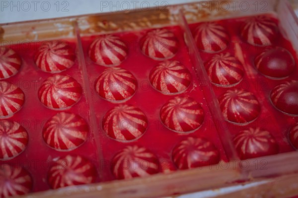 Red chocolate candy with white stripes in a chocolate mold, Christmas baking, Haselstaller Hof,
