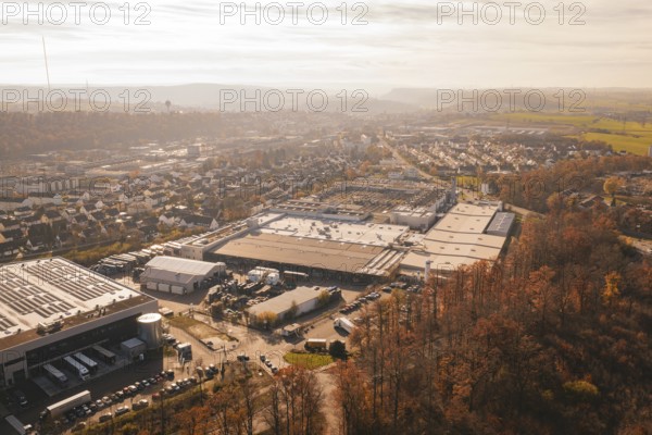Industrial complex and urban settlements surrounded by autumn vegetation, MÃ¼hlacker, Enzkreis,