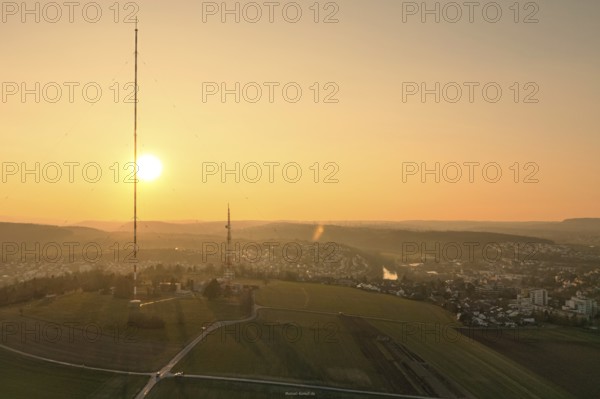 An idyllic sunset over vast fields with a dominant transmission tower, MÃ¼hlacker, Enzkreis,