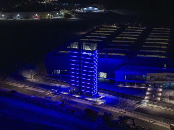 Night view of a factory with a blue illuminated tower and modern buildings, Nagold, Calw district,