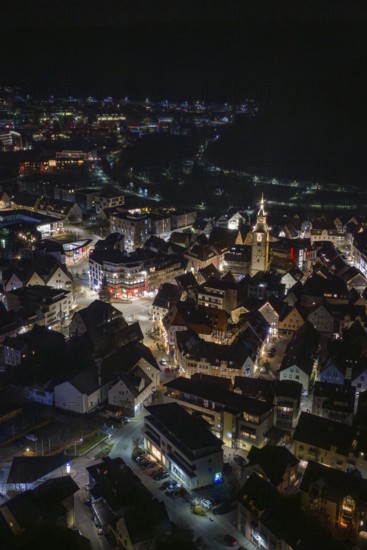 Panoramic view of a city at night with a brightly lit church tower, Nagold, Calw district, Germany