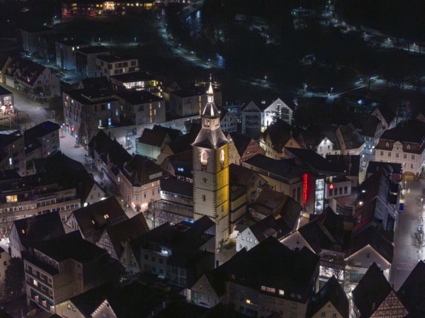 Night view of a town with a dominant, illuminated church tower in the middle, Nagold, Calw