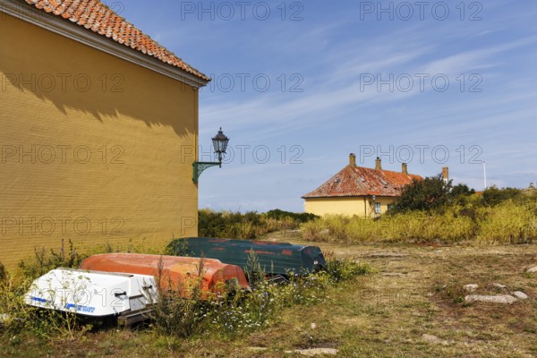 Rural coastal landscape, traditional buildings, state prison for political prisoners, three boats,