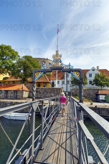 Female walker on bridge for pedestrians between ChristiansÃ¸ and FrederiksÃ¸, Christiansö and