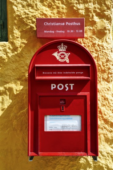 Post office, faÃ§ade detail, red mailbox with post horn and crown, yellow wall, ChristiansÃ¸,