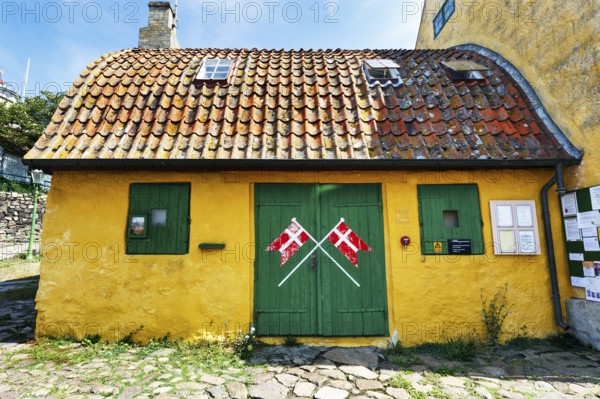 ChristiansÃ¸ Skole, smallest school in Denmark, curved tile roof, characteristic yellow and green,