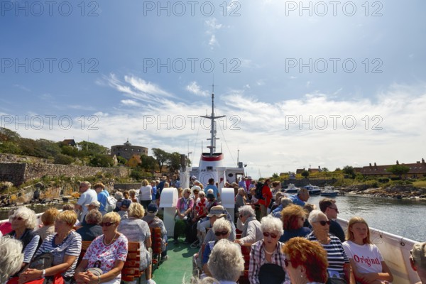 Group of tourists on ferry Ertholm, Danish passenger ship to Gutjem, ChristiansÃ¸, Christiansö,