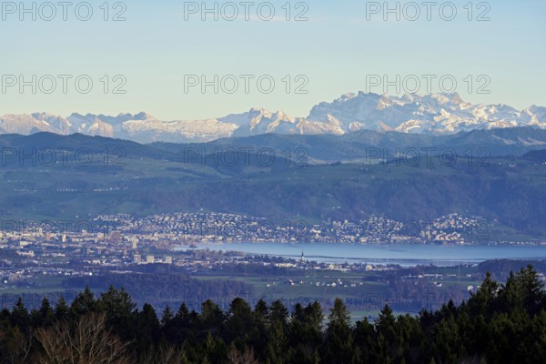 View from Horben of the city of Zug with Lake Zug, with the snow-covered Glarner Alps in the