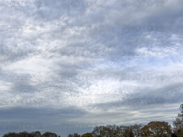 Extensive cloud cover with large layer of altostratus clouds with bag-shaped bulges at the bottom