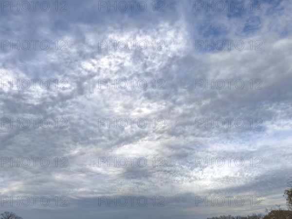 Extensive cloud cover with large layer of altostratus clouds with bag-shaped bulges at the bottom