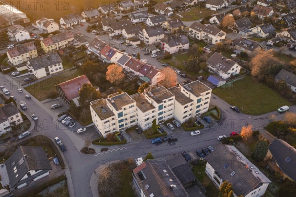 View of apartment buildings in a suburban neighborhood with parked cars, Althengstett, Calw