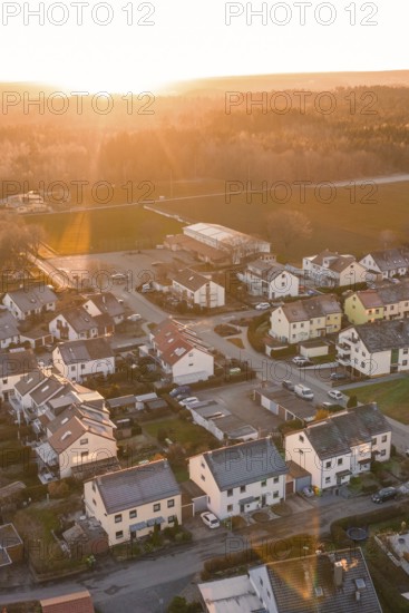 Suburb with houses and streets, illuminated by the evening sun, surrounded by nature, Althengstett,