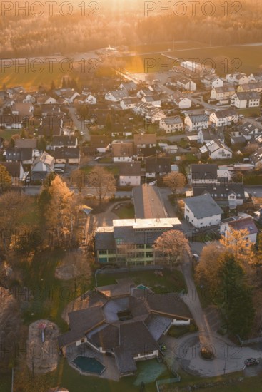 View of residential area from the air with autumn trees and sunset atmosphere, Althengstett, Calw
