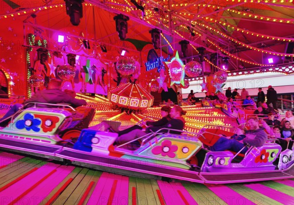 People on the Musik-Express ride at the All Saints Fair, the biggest old town fair in Europe,