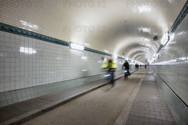 Interior view, pedestrians and cyclists crossing tunnel, mopping effect, movement, tube, historic