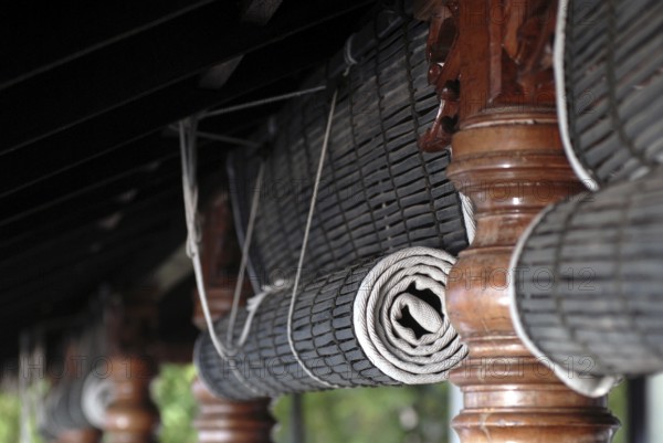 Close-up view of rolled bamboo blinds and artfully turned wooden posts, Heritage Hotel Privacy,