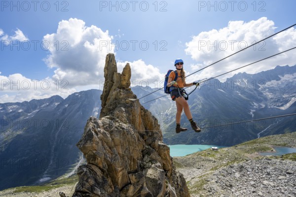 Crocodile rock formation, mountaineer on rope bridge in the Crocodile Mountain Lake via ferrata on