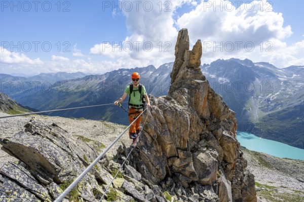 Crocodile rock formation, mountaineer on rope bridge in the Crocodile Mountain Lake via ferrata on