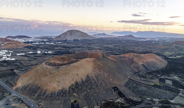 Picturesque volcanic landscape with volcanic craters MontaÃ±a de la Tabaiba at sunrise, Parque