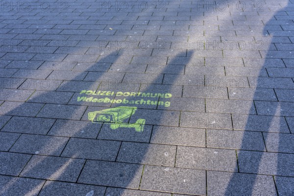 Note, sprayed on the ground that the police have set up comprehensive video surveillance in the