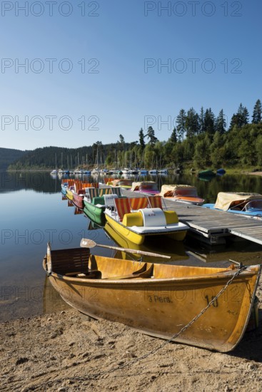 Morning atmosphere with colorful paddle boats and rowing boats, Schluchsee, Black Forest, Southern