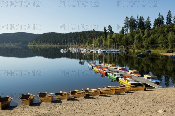 Morning atmosphere with colorful paddle boats and rowing boats, Schluchsee, Black Forest, Southern