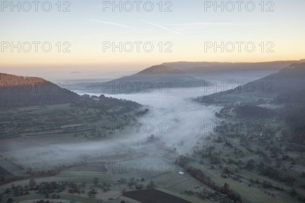 View of the foggy Neidlinger Valley in autumn at sunrise, Swabian Alb