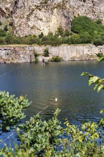Tourist on a zip line across the lake, Opal Lake in the granite quarry, MoselleÃ¸kken
