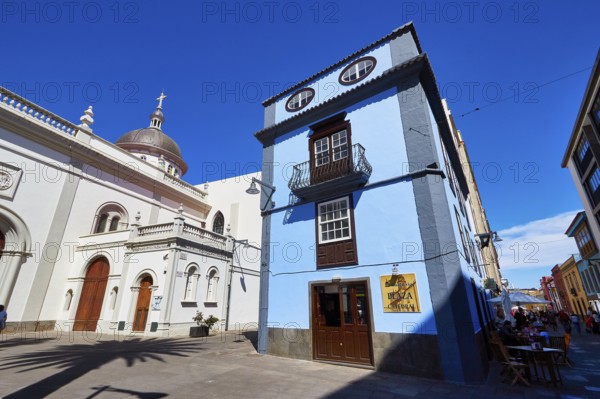 Blue building next to a historic domed church in the shadow of another building, UNESCO World