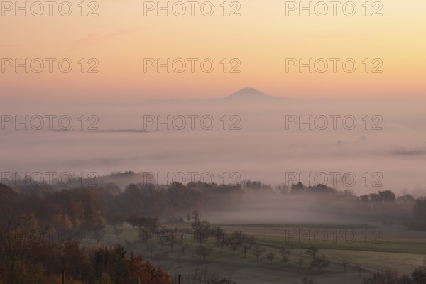 Hohenstaufen in the golden morning light, Aichelberg. Spectacular dawn over the foggy foothills of