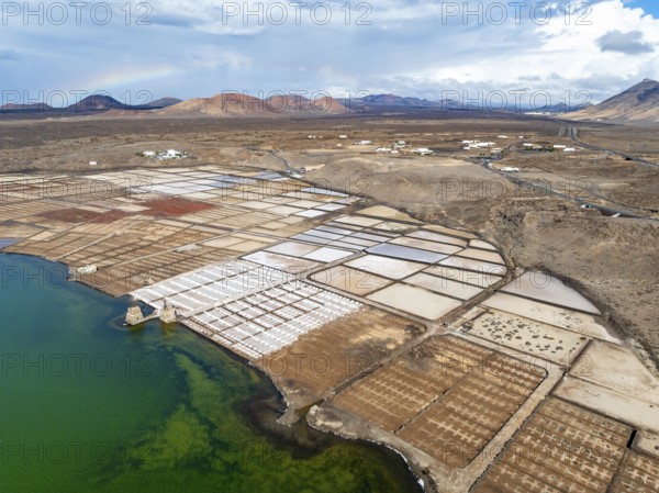 Salt mining plant, Salinas de Janubio with green Laguna de Janubio, near Yaiza, aerial view,