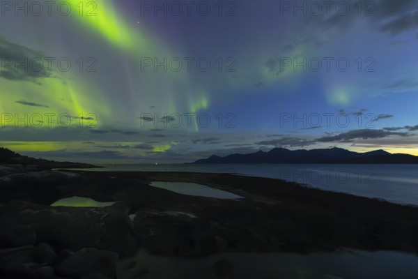 Northern lights at dawn over SÃ¸rfolda Fjord near KjerringÃ¸y between BodÃ¸ and SÃ¸rfold in Norway