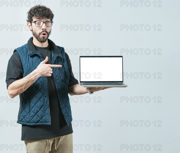 Portrait of bearded handsome man showing laptop screen isolated. Surprised Handsome Man with