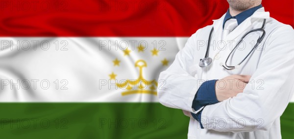 Tajikistan healthcare concept. Male doctor on Tajikistan flag. Doctor with crossed arms on