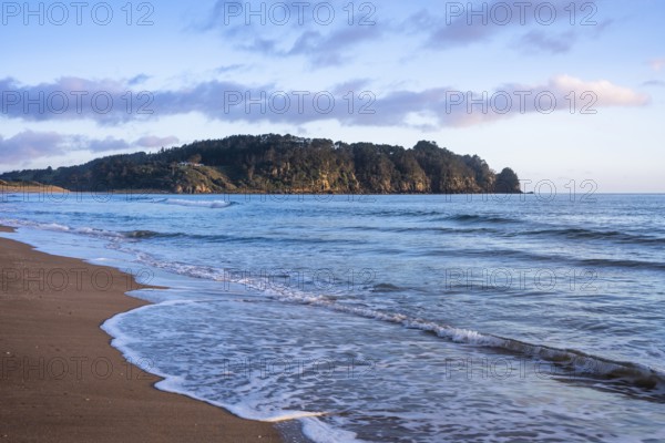 Landscape with sea and sandy beach in New Zealand. Hot Water Beach, Coromandel Peninsula, Waikato,