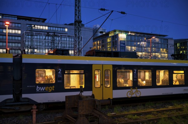 Incoming train, regional express, RE, bwegt, with bicycle compartment, in the background BW Bank,