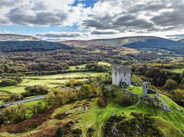 Autumn colours over Castell Dolwyddelan and Eryri Mountains from a drone, Snowdonia, Conwy County