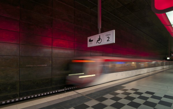 HafenCity University underground station, illuminated in color, red, underground train, movement