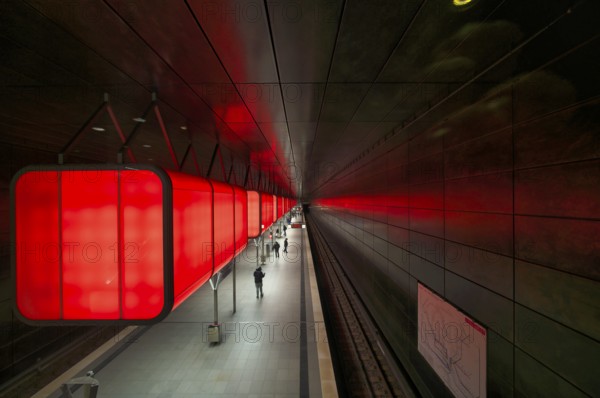 HafenCity University subway station, illuminated in color, red, travelers, platform, stop, train