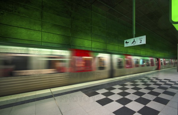HafenCity University underground station, illuminated in color, green, underground train, movement